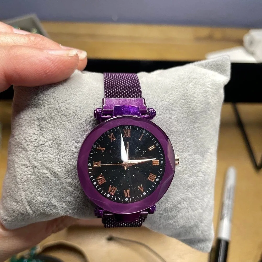 Purple watch with faceted crystal, Roman numerals and starry background
